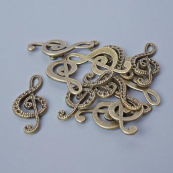 Fornitura pendente 'Chiave di violino', diametro 33×14,5 mm, foro 5,5×2 mm, confezione 11 pezzi ±, colore bronzo del metallo