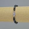Braccialetto in shungite (singolo) con perle lisce, diametro 6 mm +/- (elastico), lunghezza 18 cm +/- con inserti «Occhio»