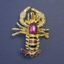 Spilla «Omar» viola e nera smaltata su metallo dorato 58×43 mm