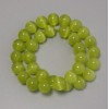 Perline «Occhio di Gatto» di colore oliva, pietra sintetica, sfera liscia, diametro circa 11,5 mm, infilate su filo, lunghezza circa 37 cm