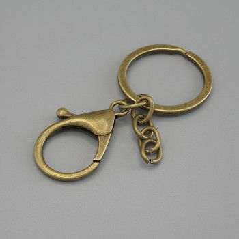 Prezzo per confezione /10 pezzi. Base per portachiavi con due ganci a moschettone 33×24 mm +- e anello, diametro 3 cm, lunghezza 7 cm