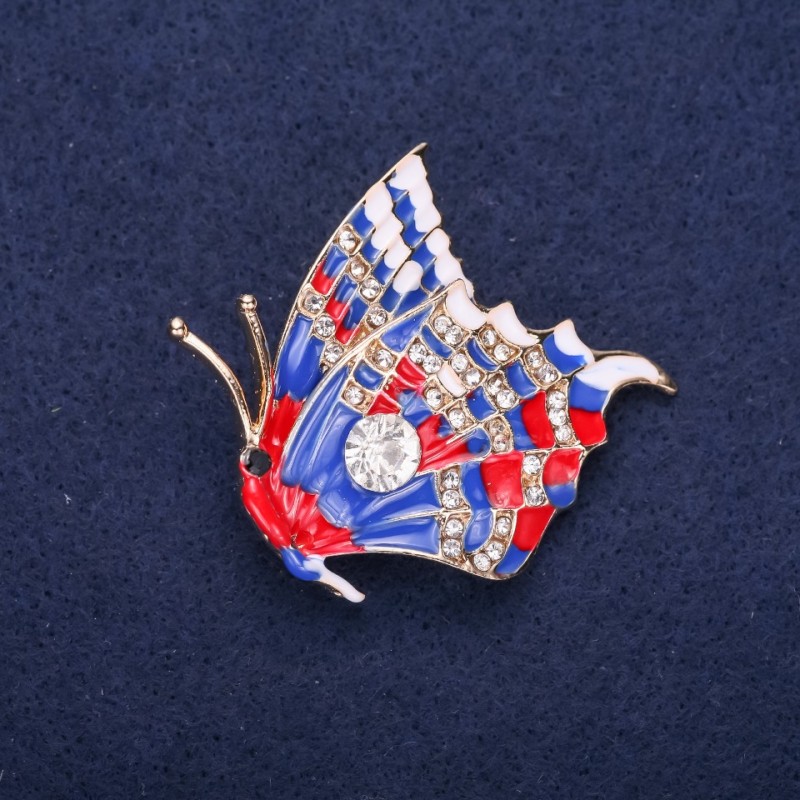 Spilla farfalla con strass bianchi e smalto blu e rosso, 40x38 mm, metallo giallo