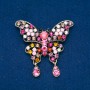 Spilla a forma di farfalla in metallo dorato, strass multicolori 48 × 60 mm +