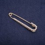 Spilla a spillo con strass bianchi 57×13 mm metallo dorato