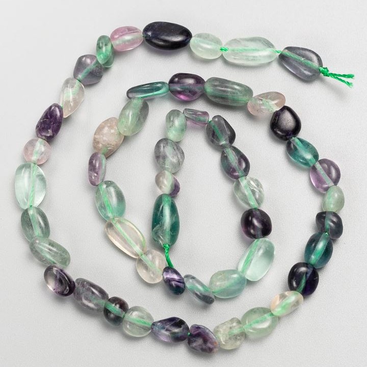 Perline su filo in fluorite levigate Ø 7×11-6×8 mm +-, lunghezza circa 40 cm